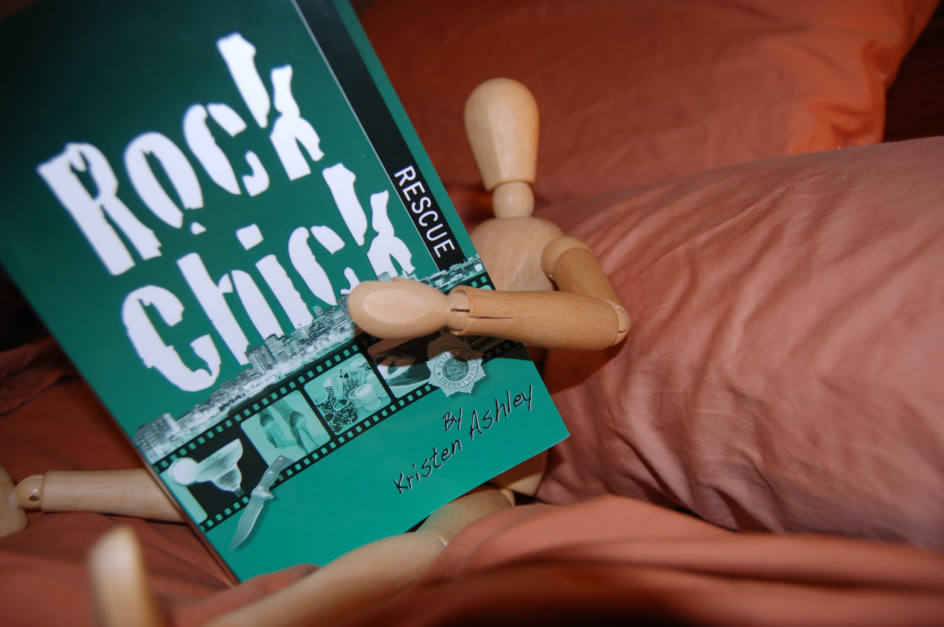 Reading Rock Chick Rescue in bed